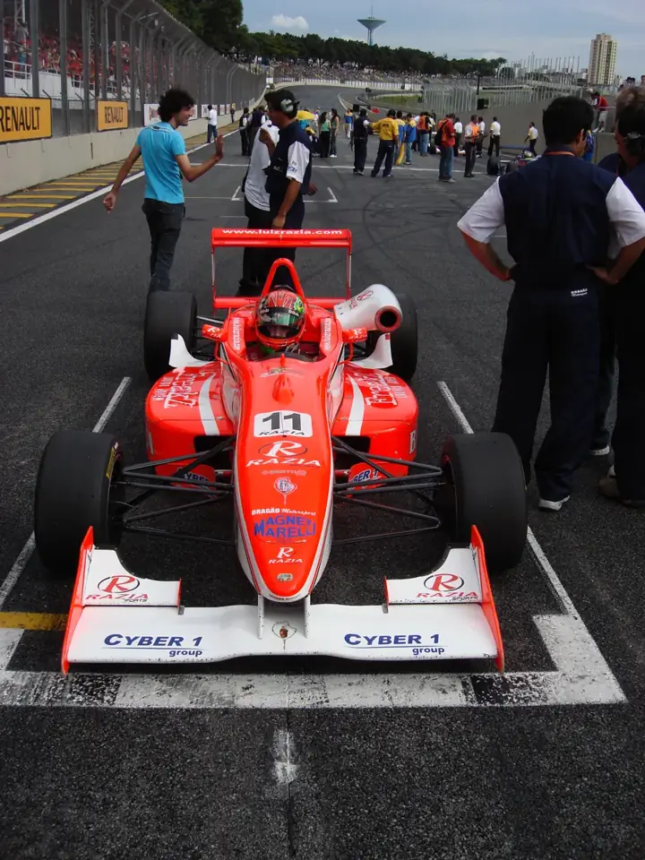 Car with the Cyber1 group logo on the starting grid